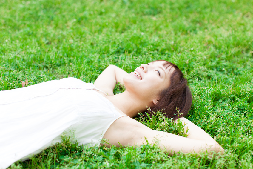 芝生の上に寝る女性